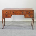 A Queen Anne style writing desk, with a red inset writing surface, on cabriole legs,