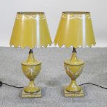 A pair of tole style yellow metal painted table lamps and shades,