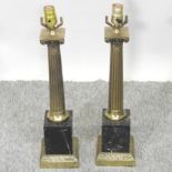 A pair of black marble and gilt mounted table lamps,