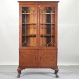 A mahogany cabinet bookcase, on claw and ball feet,