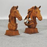 A pair of rusted cast iron horse head gatepost finials,