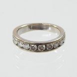 An unmarked diamond half hoop eternity ring,