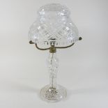 An early 20th century cut glass table lamp, with a glass shade,