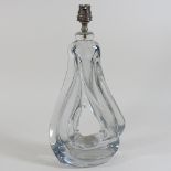 An early 20th century heavy glass lamp base, of abstract form,
