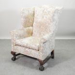 A mid 20th century American floral upholstered wing armchair,