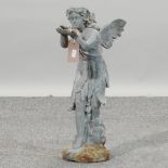 A cast iron figure of a fairy holding a bird,