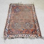 A woollen rug, with geometric design, on a red ground,