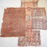 A woollen rug with four central medallions, within multiple borders, on a red ground, 180 x 129cm,