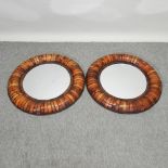 A pair of circular wooden wall mirrors,