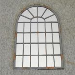 A metal framed arched wall mirror,