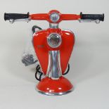 A lamp in the form of a red scooter,