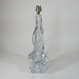 An early 20th century French heavy glass lamp base, of twisted abstract form,