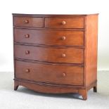 A mahogany bow front chest of drawers, together with a reproduction chair,