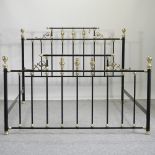 A black painted metal and ornate brass bed frame, from And So To Bed,