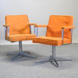 A pair of 1960's orange upholstered armchairs