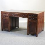 An oriental hardwood pedestal desk,