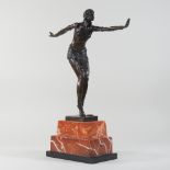 An Art Deco style bronze model of a girl, on a marble base,