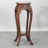 A Chinese marble top jardiniere stand,