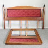 A modern padded headboard, 196cm, together with a modern cherrywood framed wall mirror,