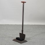 A boot scraper in the form of a spade,