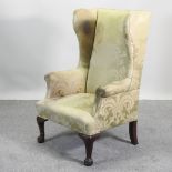 A 19th century green upholstered wing armchair