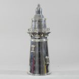 A modern plated cocktail shaker, in the form of a lighthouse,