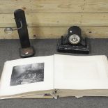 A 19th century black slate mantel clock, together with a magnifier on an oak stand,