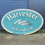 A large oval 'Harvester' pub sign,