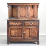 A 19th century and later oak court cupboard, enclosed by panelled doors,