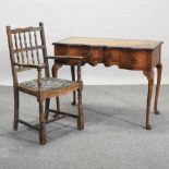 A 1930's walnut writing desk, 99cm, together with an open armchair,