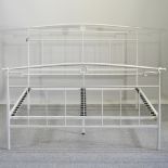 A cream painted metal bedstead,