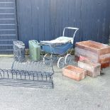 A vintage doll's pram, together with two metal hay racks, largest 105cm,