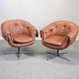 A pair of mid 20th century brown upholstered swivel chairs