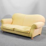 A modern yellow upholstered sofa, on turned legs,