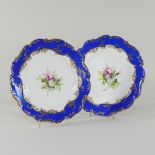 A pair of 19th century Coalport style porcelain cabinet plates, each painted with flowers,