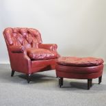 A red leather upholstered tub shaped armchair,