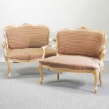 A pair of French style gilt and patterned upholstered show frame sofas, on cabriole legs,