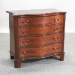 A George III style mahogany serpentine chest of drawers,