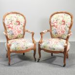 A pair of Victorian style floral upholstered show frame armchairs