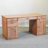 A modern pine twin pedestal desk,