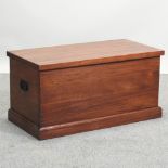 A handmade hardwood trunk, with metal handles,