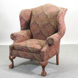 A floral upholstered wing armchair, of large proportions,