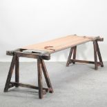 A vintage military stretcher, on stands,