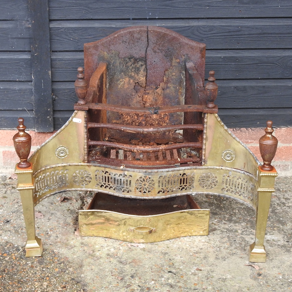 A cast iron and brass fire basket,