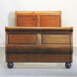 A French walnut bedstead, with a wooden slatted base,