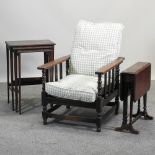 A 1920's reclining armchair, together with a sutherland table and a nest of three occasional tables,