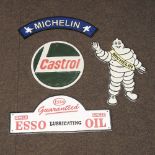 A reproduction curved Michelin sign, together with a Michelin plaque, a Castrol sign,