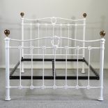 A white painted metal bedstead,