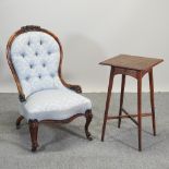 A Victorian mahogany and blue upholstered nursing chair, the arms carved in the form of dolphins,