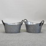 A pair of metal oval planters,